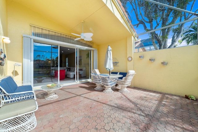 view of patio / terrace featuring a lanai and ceiling fan