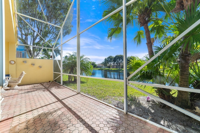 unfurnished sunroom with a water view