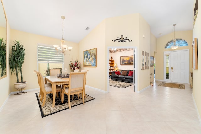 tiled dining room with high vaulted ceiling and a notable chandelier