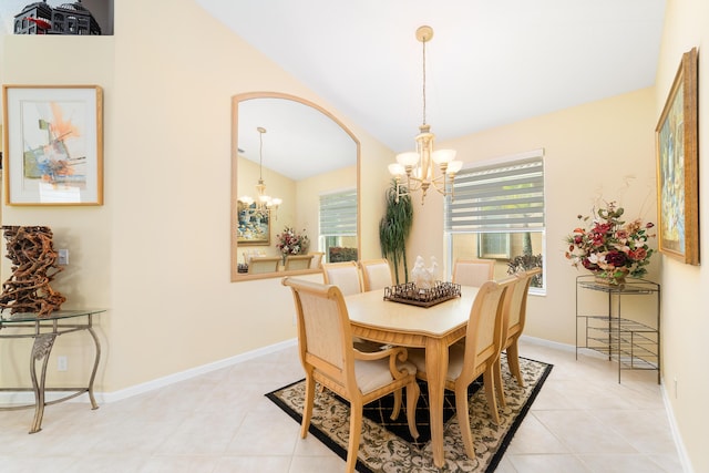 dining area with lofted ceiling, a chandelier, and light tile patterned floors