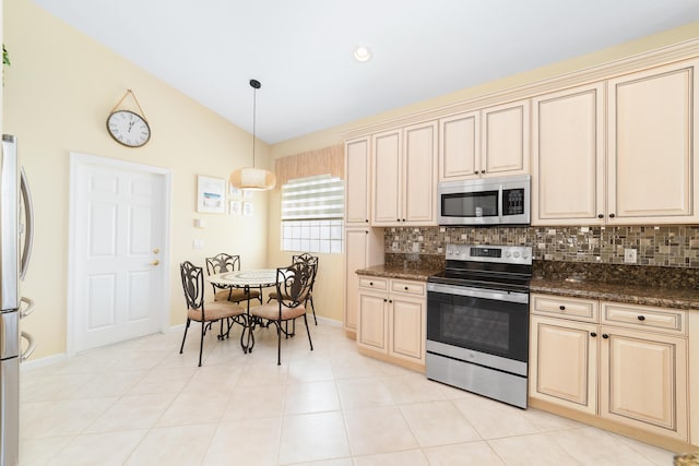 kitchen featuring stainless steel appliances, decorative light fixtures, decorative backsplash, and dark stone countertops