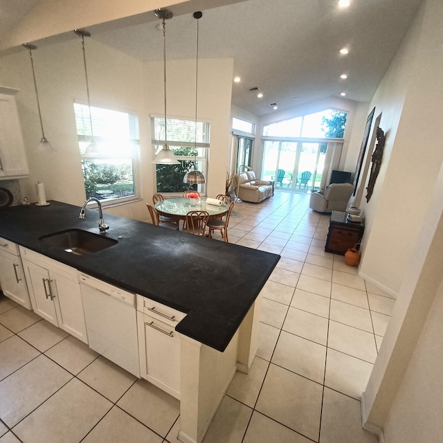 kitchen featuring lofted ceiling, decorative light fixtures, white cabinetry, sink, and white dishwasher