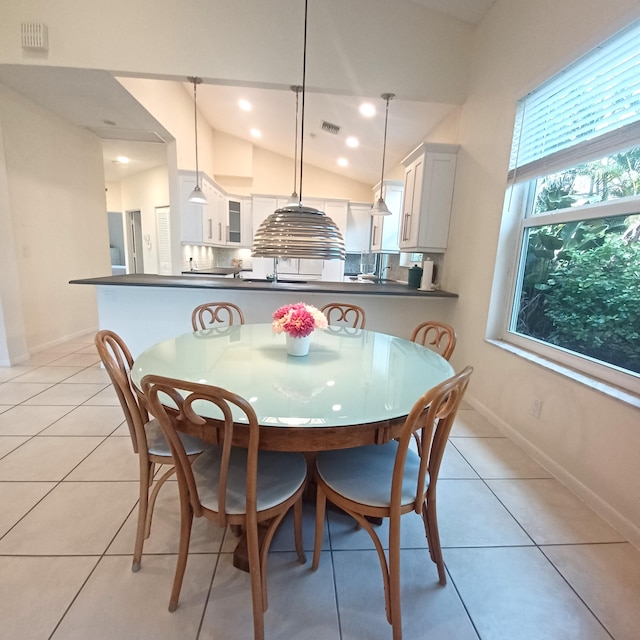 tiled dining room with vaulted ceiling