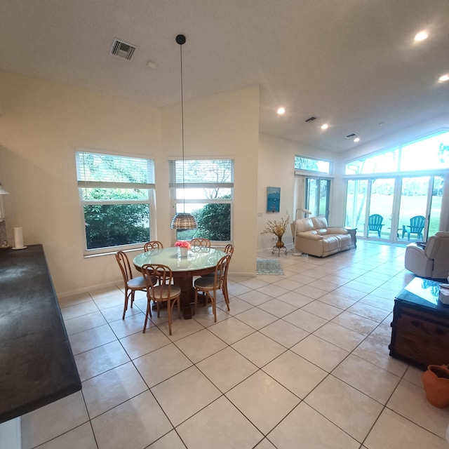 dining space with light tile patterned flooring and a high ceiling