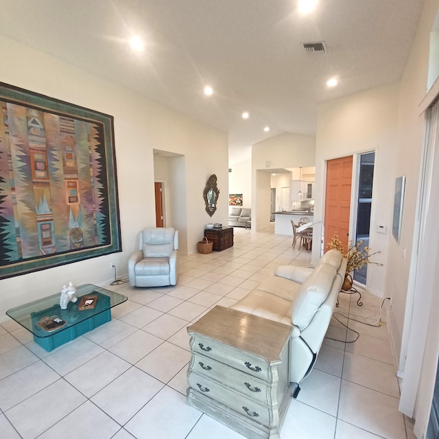 living room with light tile patterned flooring and vaulted ceiling