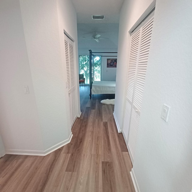 hallway with wood-type flooring