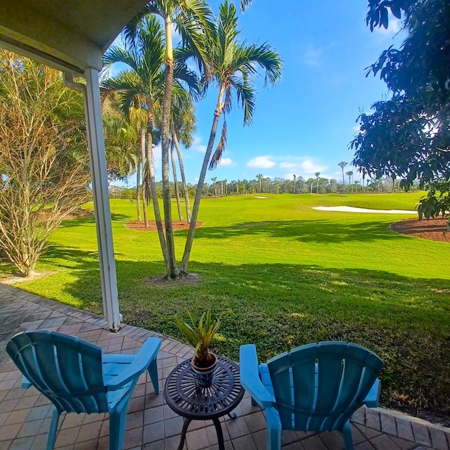 view of home's community with a lawn and a patio