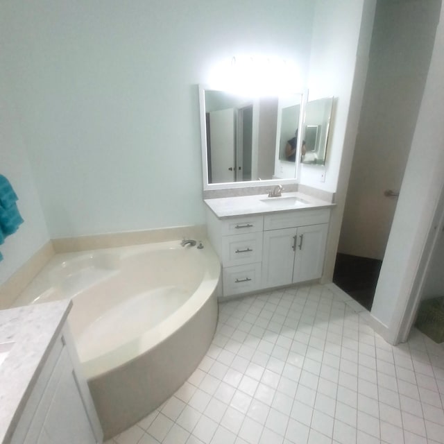 bathroom featuring vanity, tile patterned flooring, and a bath