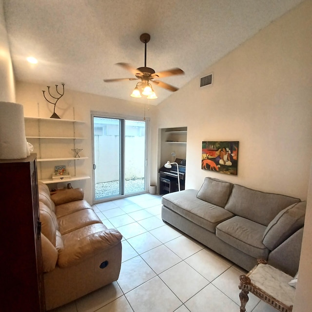 tiled living room with ceiling fan, a textured ceiling, and lofted ceiling