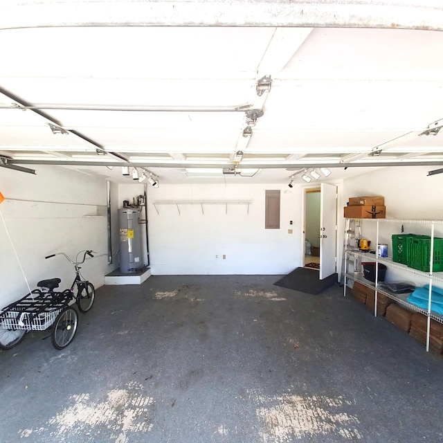 garage featuring water heater and electric panel