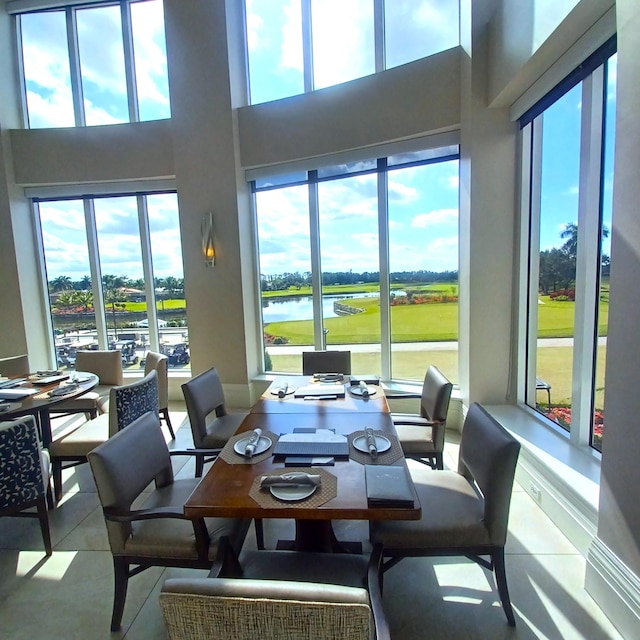 dining room with plenty of natural light and a water view