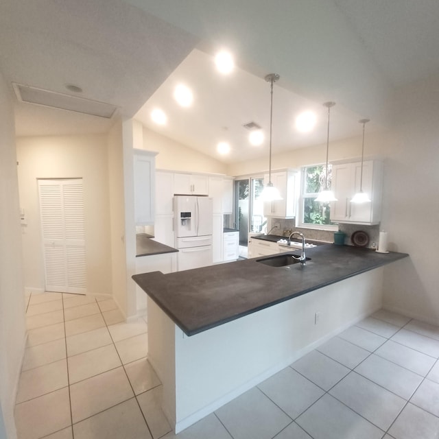 kitchen with kitchen peninsula, white refrigerator with ice dispenser, white cabinets, and sink