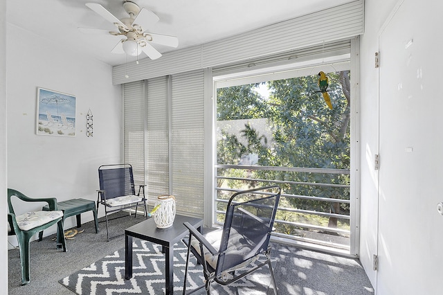 sunroom / solarium featuring ceiling fan