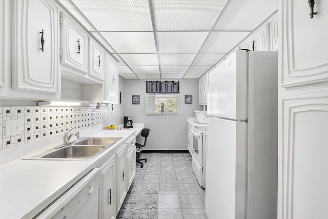 kitchen with backsplash, sink, white cabinets, and white appliances