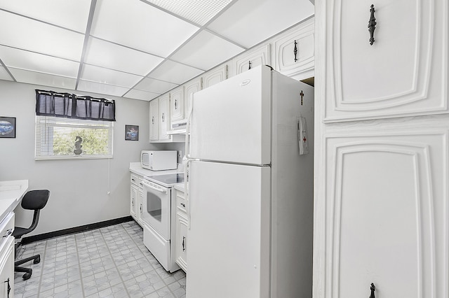 kitchen with a paneled ceiling, white cabinets, and white appliances