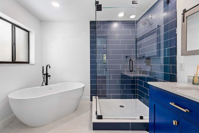 bathroom with tile patterned floors, vanity, a textured ceiling, and independent shower and bath