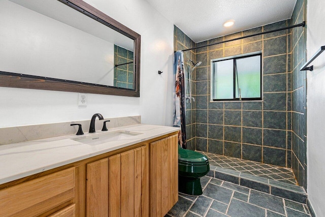 bathroom featuring vanity, curtained shower, toilet, and a textured ceiling