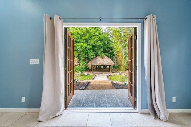 doorway to outside featuring light tile patterned flooring