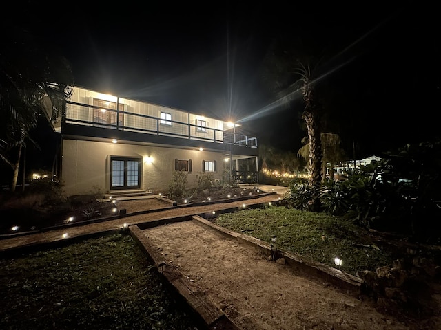 yard at night with a balcony