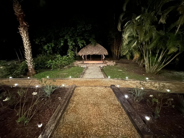 yard at night featuring a gazebo