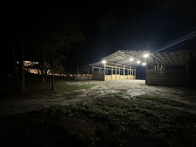 yard at night featuring an outbuilding