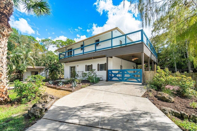 view of front of house with a balcony and ceiling fan