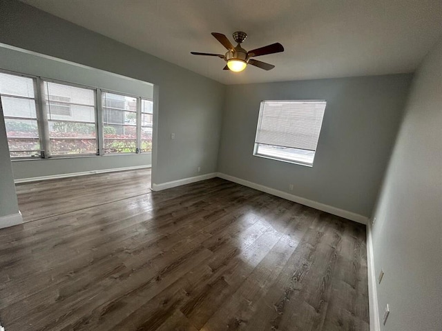 spare room featuring ceiling fan and dark hardwood / wood-style floors