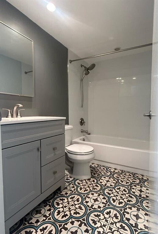 full bathroom with tile patterned floors, vanity, toilet, and tiled shower / bath