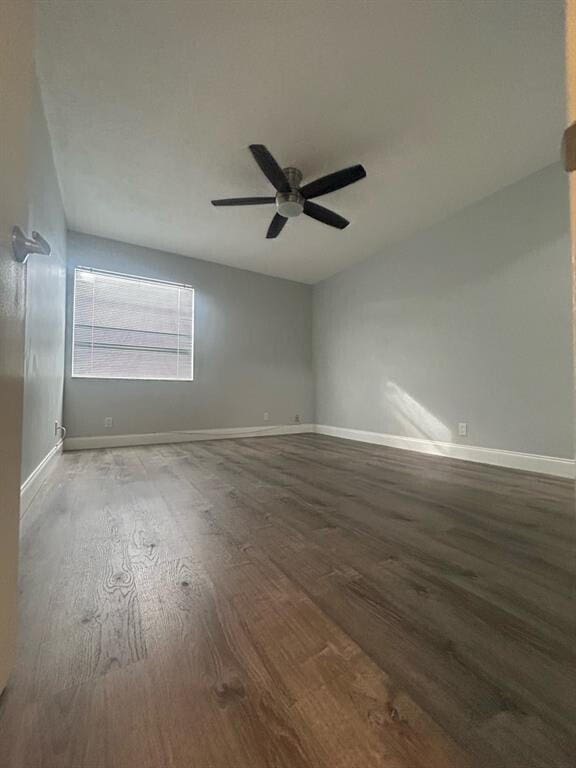 spare room with ceiling fan and wood-type flooring