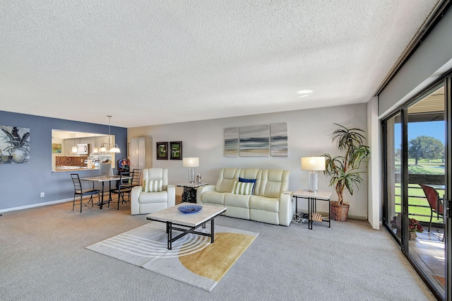 carpeted living room with a notable chandelier and a textured ceiling