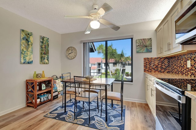 dining area featuring ceiling fan, a textured ceiling, and light wood-type flooring