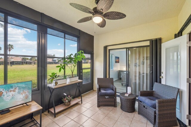 sunroom featuring ceiling fan and a healthy amount of sunlight