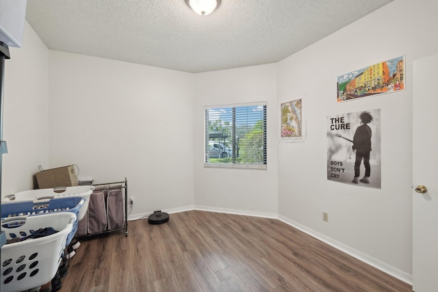 bedroom featuring wood-type flooring and a textured ceiling