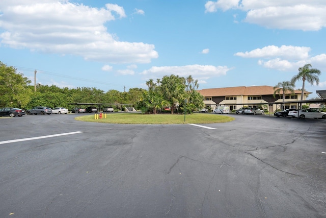 view of parking / parking lot with a lawn