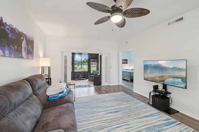 living room featuring dark hardwood / wood-style flooring and ceiling fan