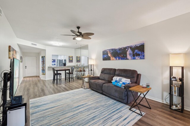 living room with hardwood / wood-style floors and ceiling fan