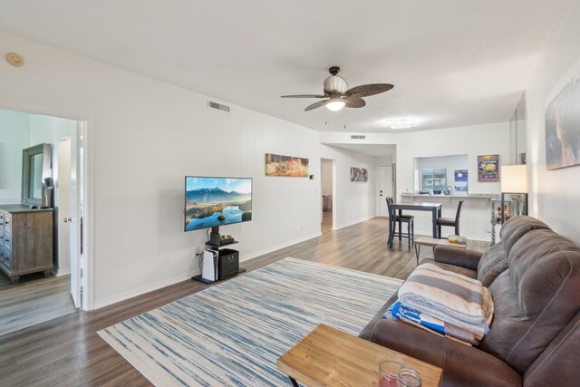 living room with ceiling fan and hardwood / wood-style floors