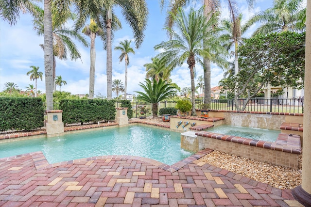 view of swimming pool with an in ground hot tub and pool water feature