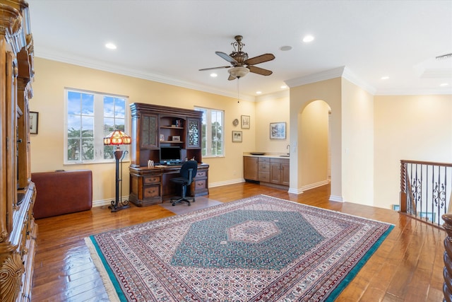 office featuring hardwood / wood-style flooring, crown molding, and ceiling fan