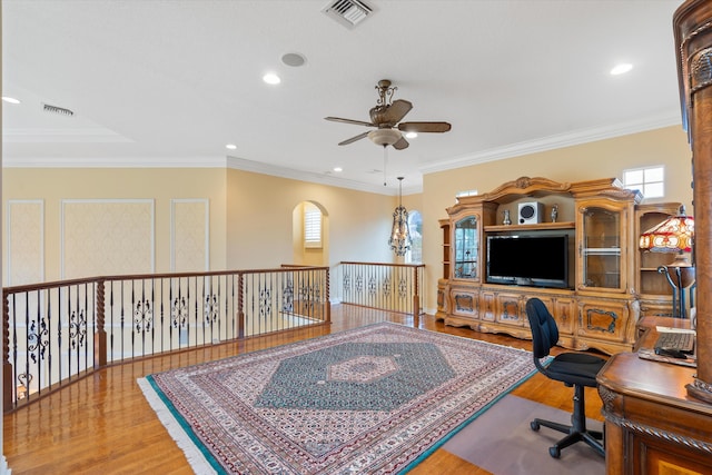 home office featuring crown molding, hardwood / wood-style floors, and ceiling fan