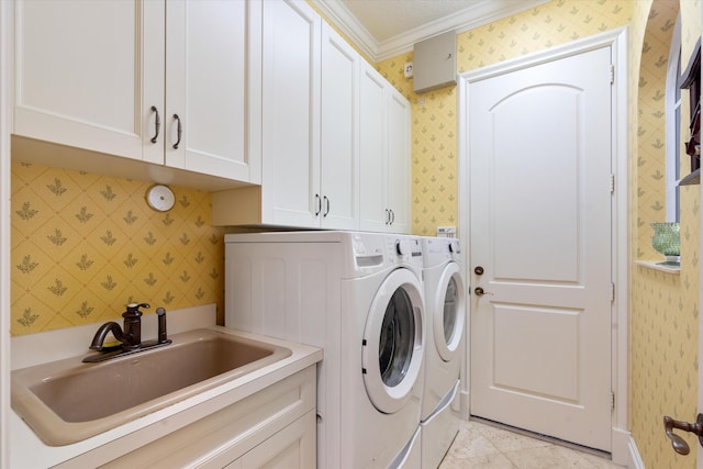 clothes washing area with cabinets, crown molding, separate washer and dryer, and sink