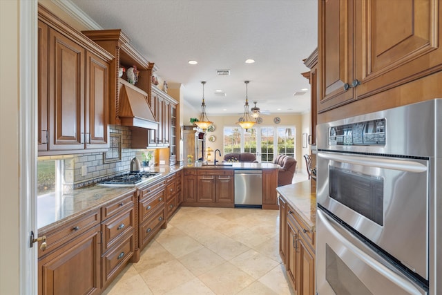 kitchen with pendant lighting, sink, kitchen peninsula, stainless steel appliances, and custom range hood