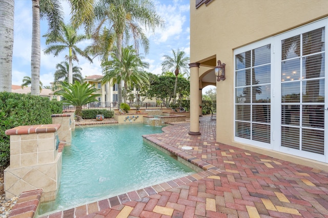 view of pool featuring pool water feature and a patio area