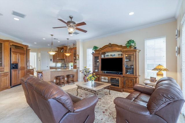 tiled living room featuring sink, ornamental molding, and ceiling fan