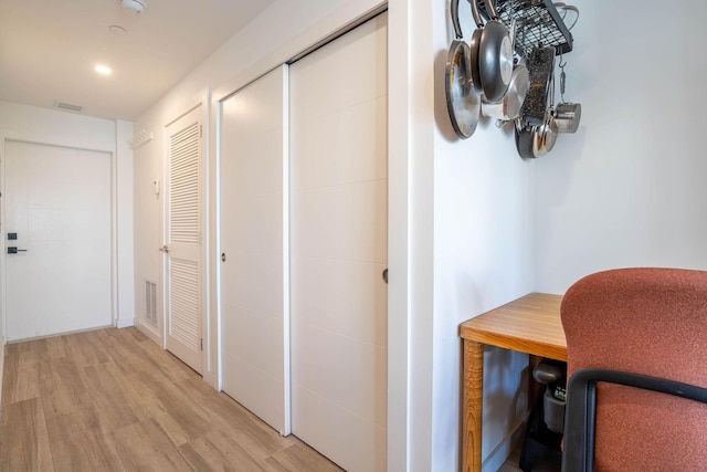 corridor with light wood-type flooring