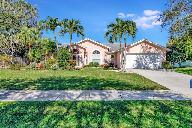 view of front of property with a front yard and a garage