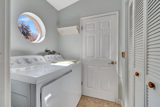 laundry area featuring washing machine and dryer and light tile patterned floors