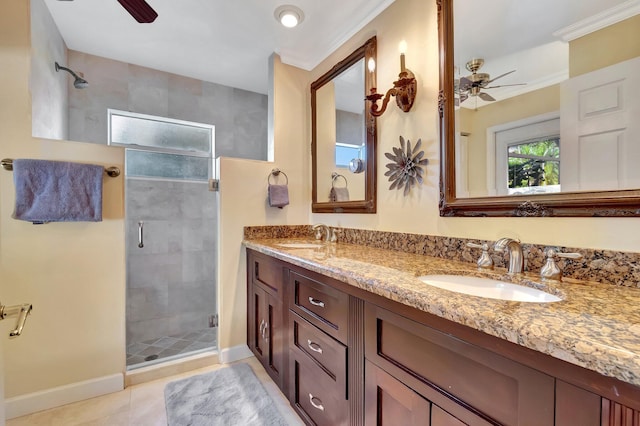 bathroom with tile patterned floors, an enclosed shower, vanity, ceiling fan, and crown molding