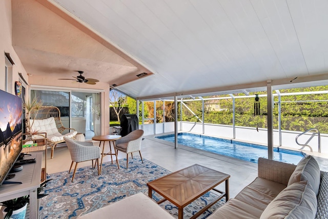 living room with concrete flooring and ceiling fan