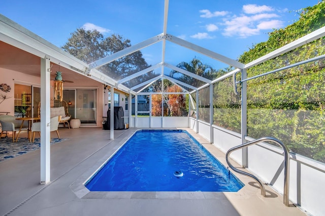 view of pool with a patio, ceiling fan, and a lanai